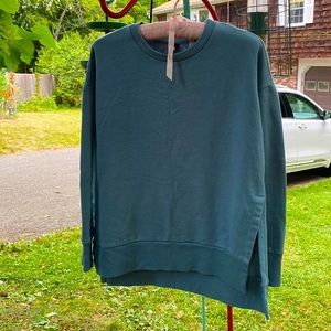 This 90 degree blue oversized sweater with a slit on both sides of the sweater